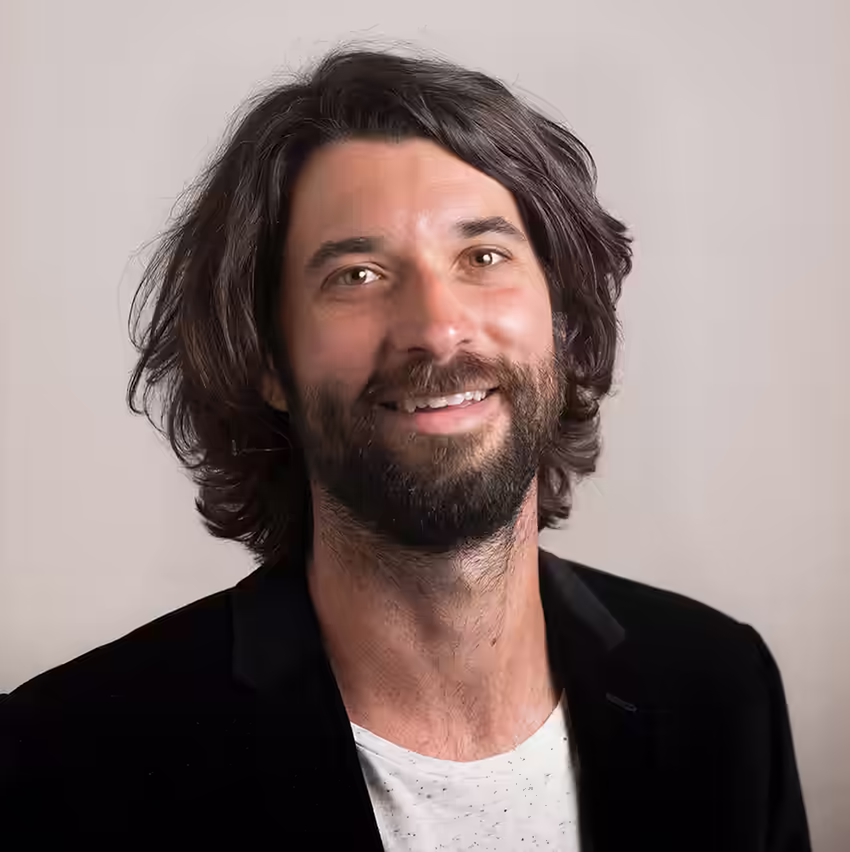 Ash Buchanan, mindset scientist and teacher, smiling in a professional headshot.